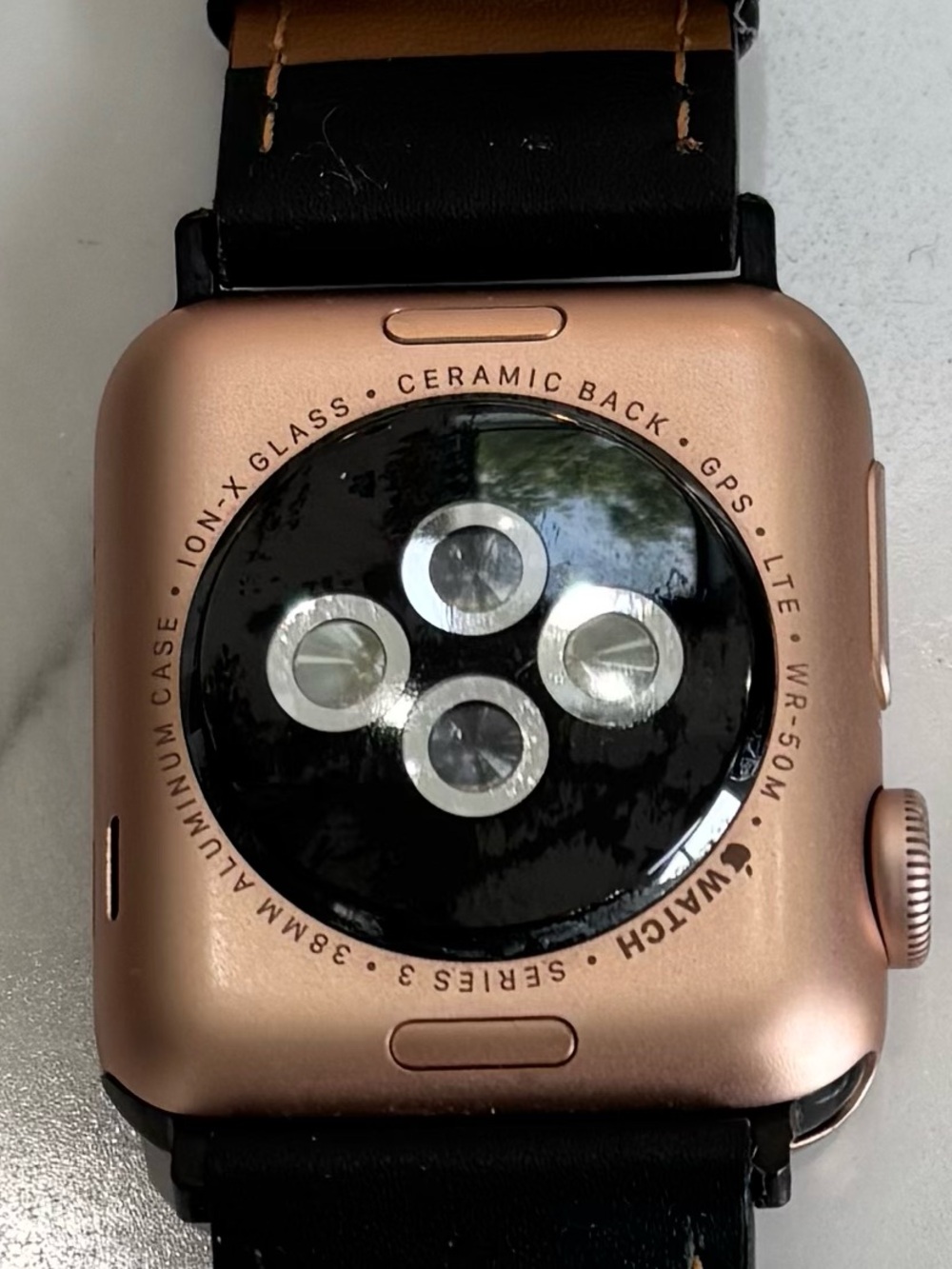 38 MM Apple Rose Gold Case Smartwatch with Black Leather Band and Tan Stitching - Picture 3 of 5